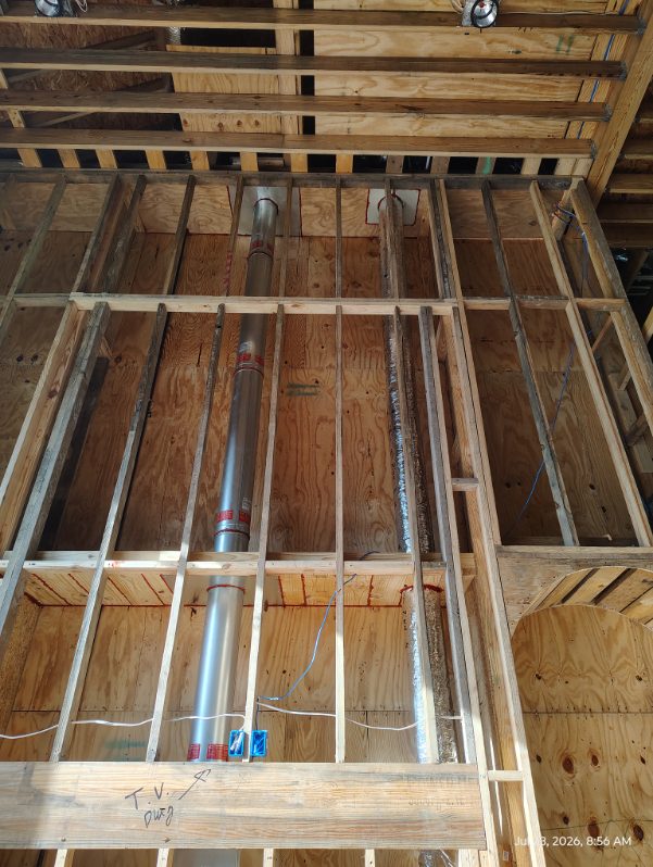 Chimney flue pipe routed through framed ceiling joists in a Houston, TX home