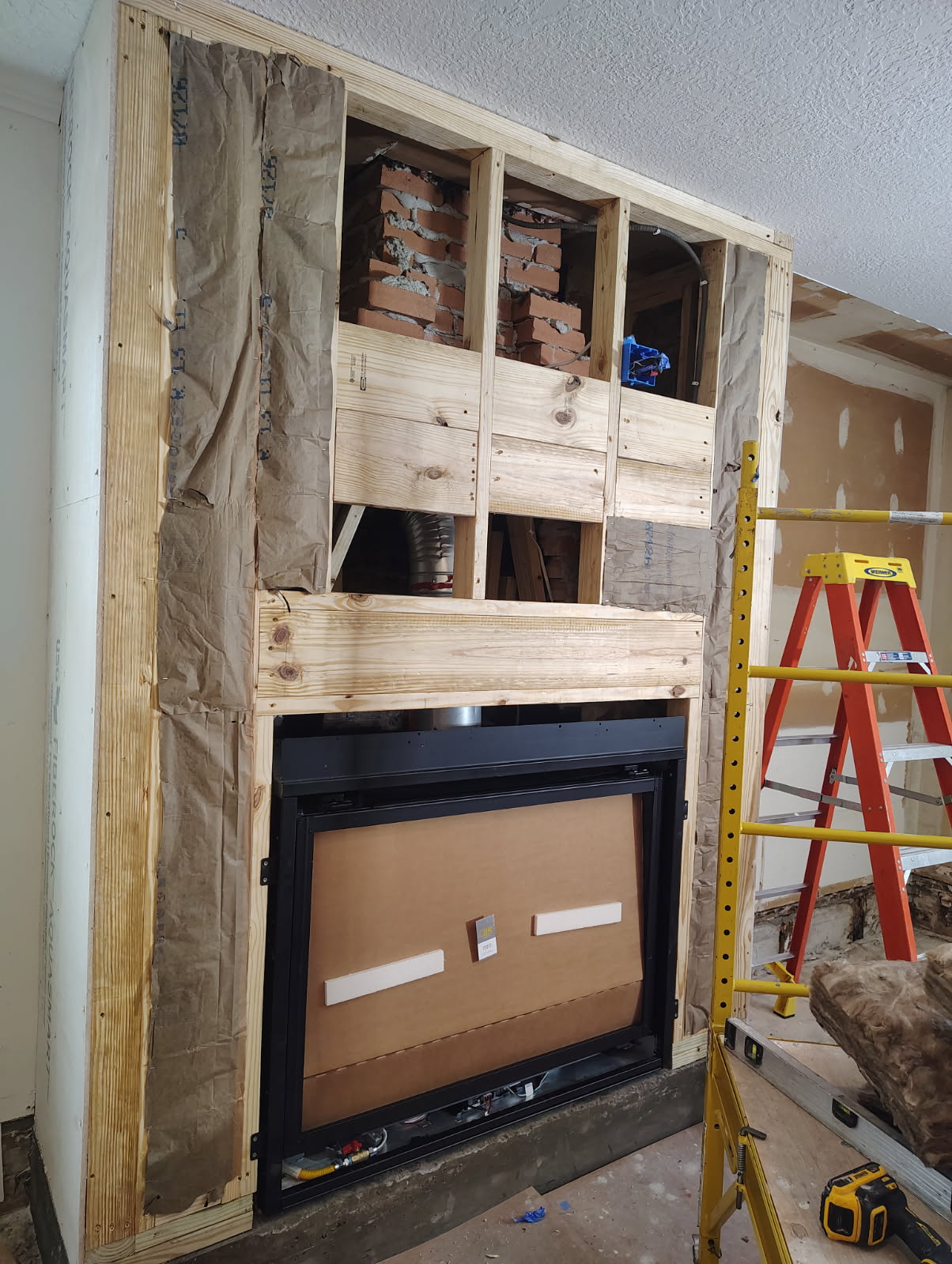 New fireplace insert framed into an existing wall opening in Houston, TX