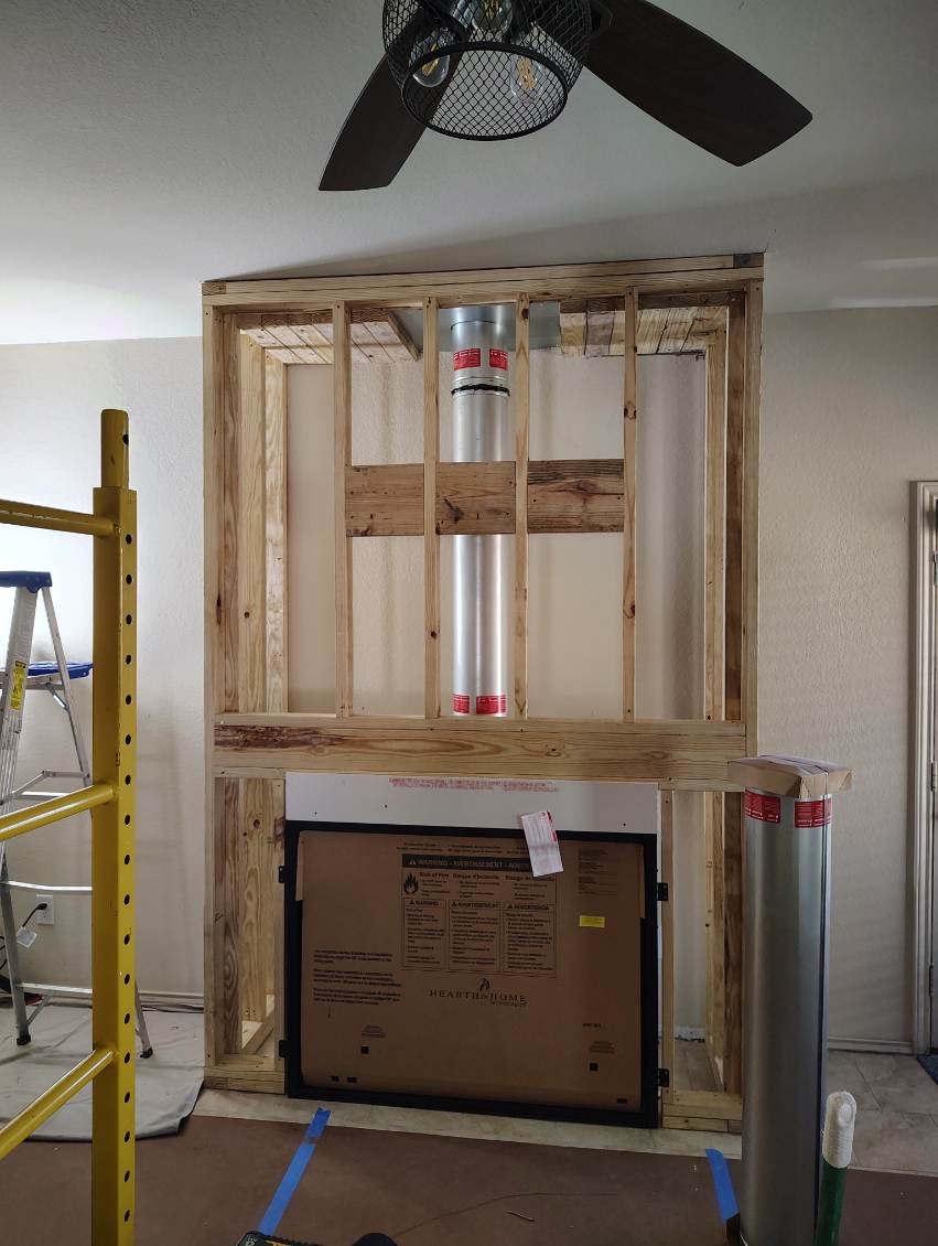 Gas fireplace chase framed with new flue pipe run to the ceiling in Richmond, TX