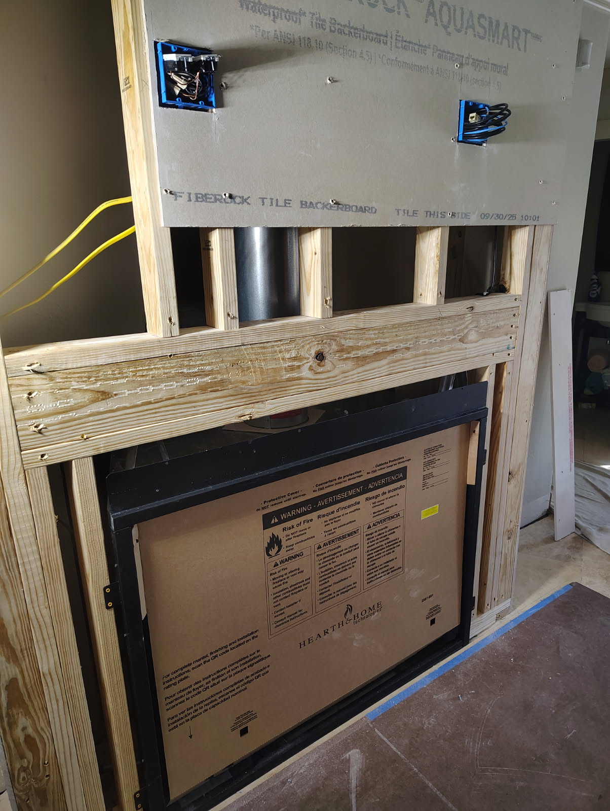 Fireplace insert being set into a framed chase in Cypress, TX