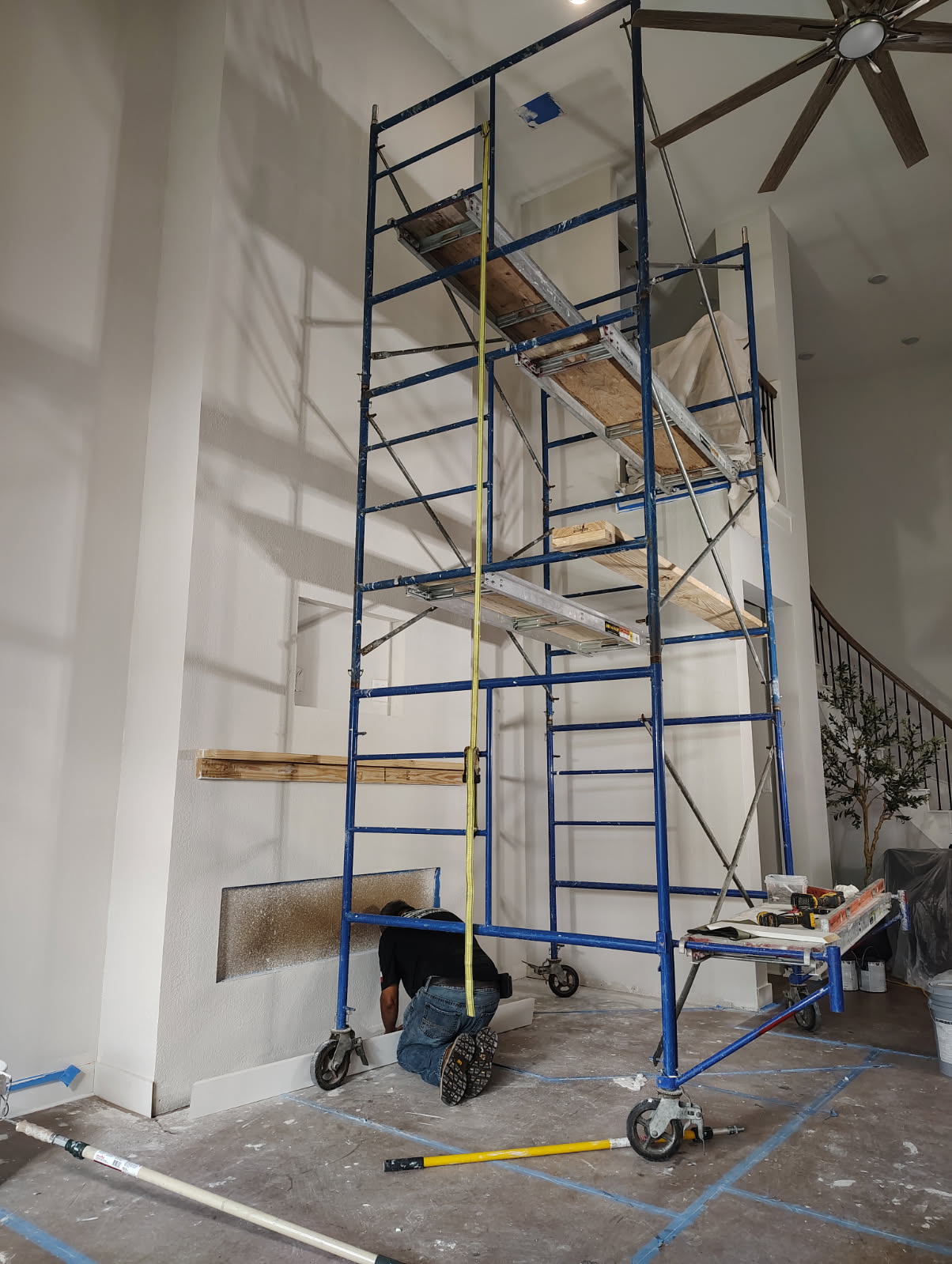 Two-story fireplace wall remodel in progress in The Woodlands, TX