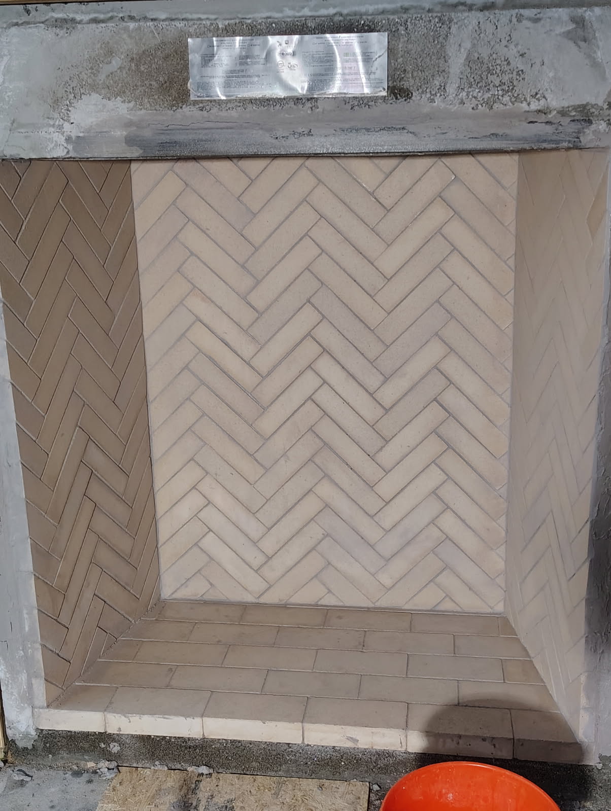 Herringbone firebrick firebox laid inside a rebuilt fireplace in Houston, TX