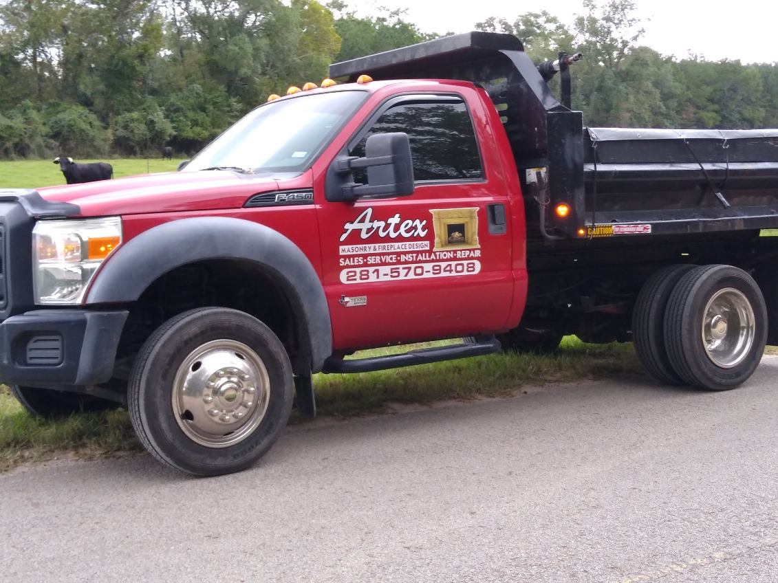 Artex Masonry & Fireplace red dump truck used for masonry material hauling in Houston, TX