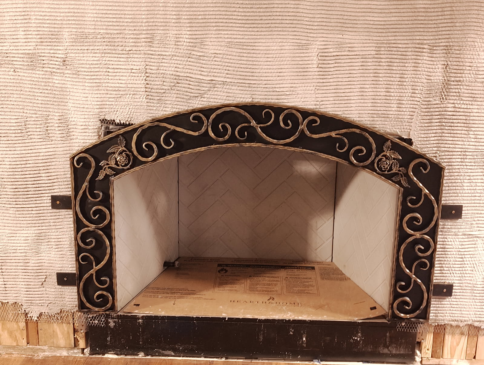 Antique iron fireplace facade restored over a rebuilt firebox in Houston, TX