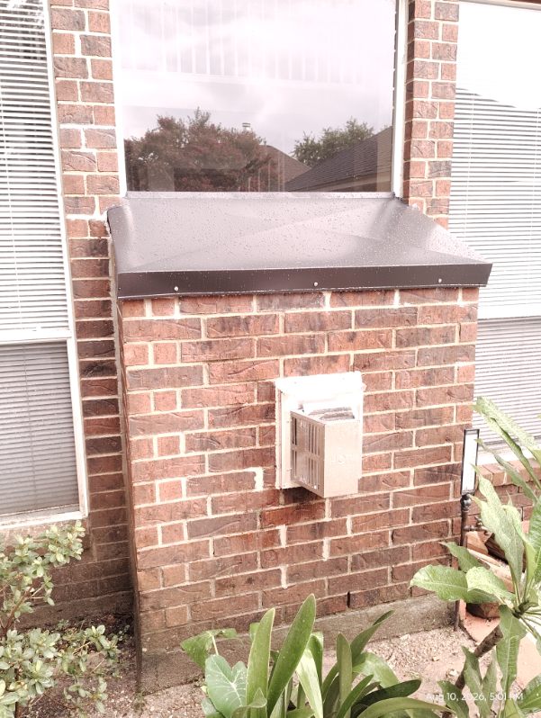 New metal chase cover installed on an exterior brick chimney chase in Spring, TX