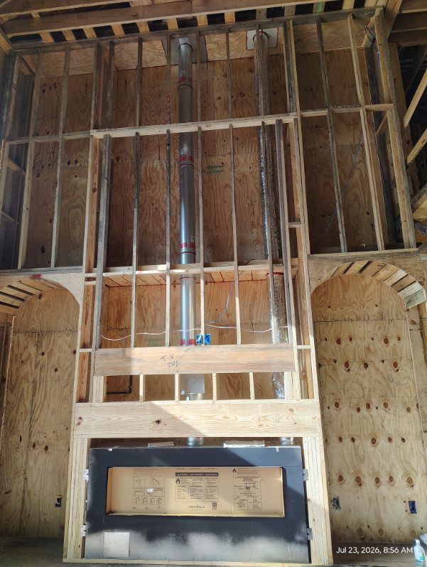 Framed fireplace chase with a new firebox set during a fireplace installation in Houston, TX