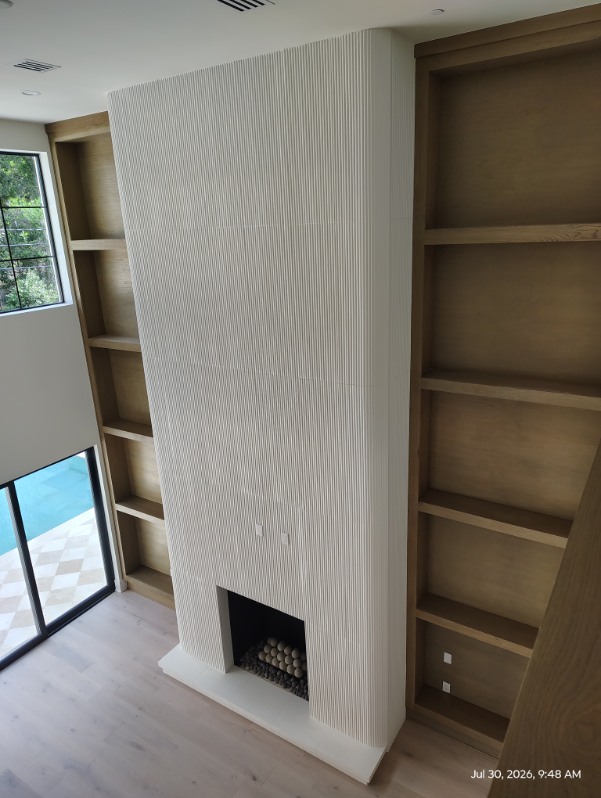 Modern fireplace with white built-in cabinetry in a Katy, TX living room