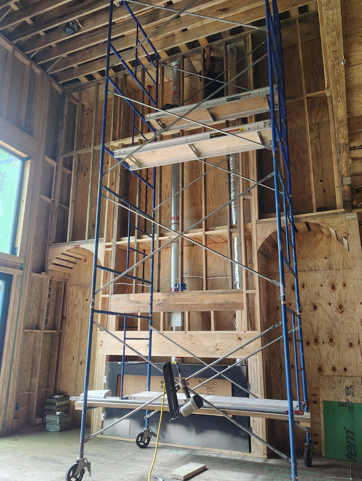 Direct vent gas fireplace installation staged on scaffolding in Houston, TX